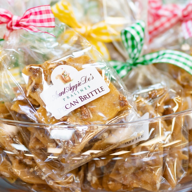 Bags of craft made Pecan Brittle packaged in decorative bags made by Aunt Aggie De's