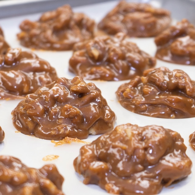 Delicious gooey Texas pecan pralines fresh on the pan before being packaged in Sinton, TX by Aunt Aggie De's Pralines